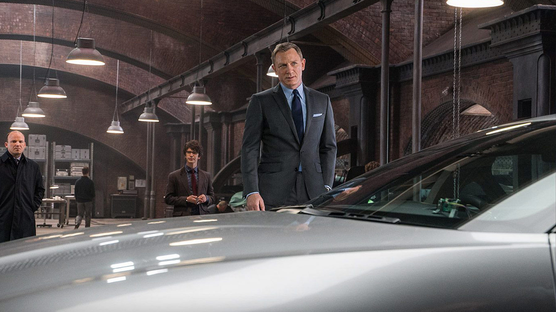 James Bond (Daniel Craig), Q (Ben Whishaw) and Tanner (Rory Kinnear) with the Aston Martin DB10 in <i>Spectre</i>. (Photo: <a href="https://www.facebook.com/SpectreMovie/photos/pb.409815059172257.-2207520000.1447991281./482603261893436/?type=3&amp;theater">Spectre’s Facebook page</a>)