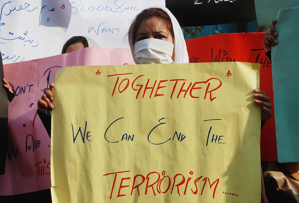 A protester holds a placard in the wake of Peshawar attacks in 2013 in Pakistan. (Photo: Reuters)
