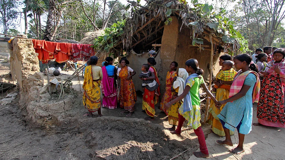 Villagers walk near the area where a woman was gang-raped by 13 men on the orders of a village court at Birbhum district, in West Bengal, January 24, 2014. (Photo: Reuters)