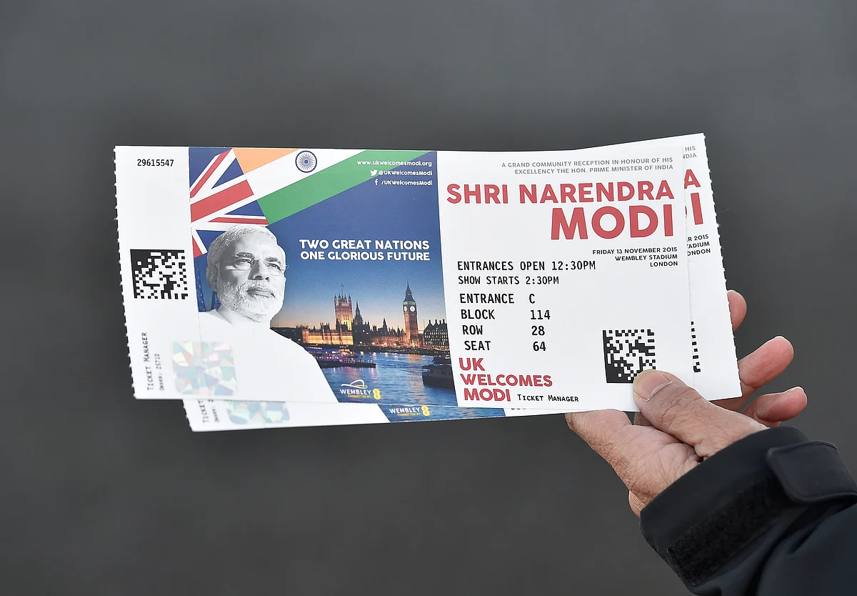 A man shows off his tickets on his way to Wembley Stadium. (Photo: Reuters)