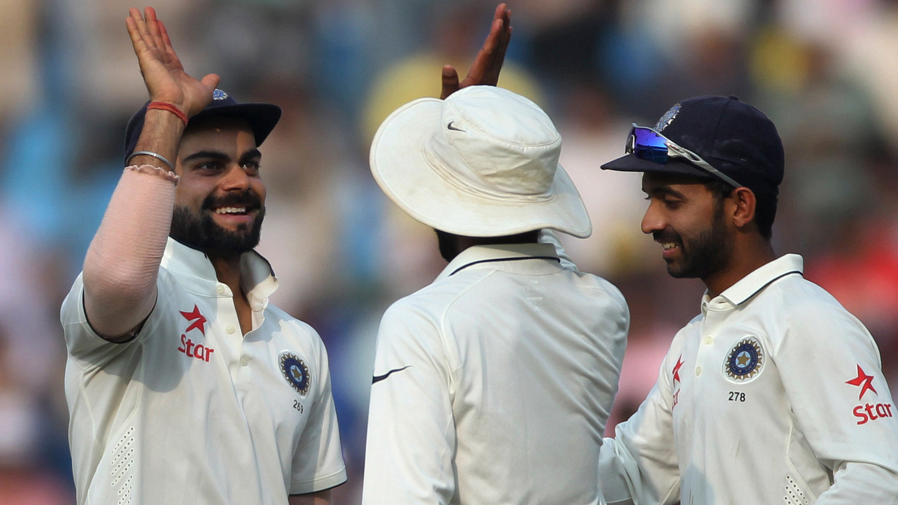Indian cricketers, (from left to right), Virat Kohli, Ravindra Jadeja and Ajinkya Rahane, celebrate as India wins against South Africa on the third day of the third cricket Test match between the two countries in Nagpur,  November 27, 2015. (Photo: AP)