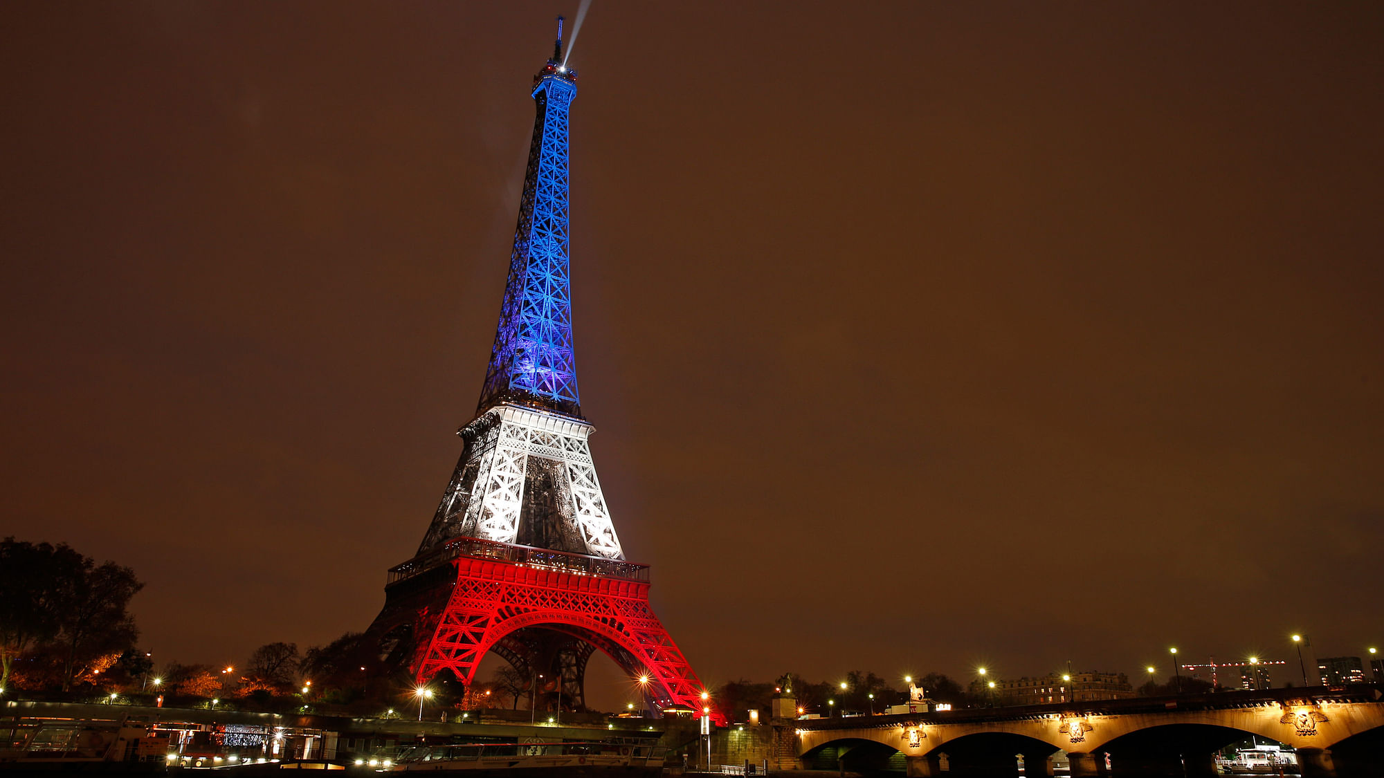 The Eiffel Tower is lit with the  colours of the French flag  to pay tribute to the victims of a series of deadly attacks in Paris on 13 November 2015. (Photo: Reuters)