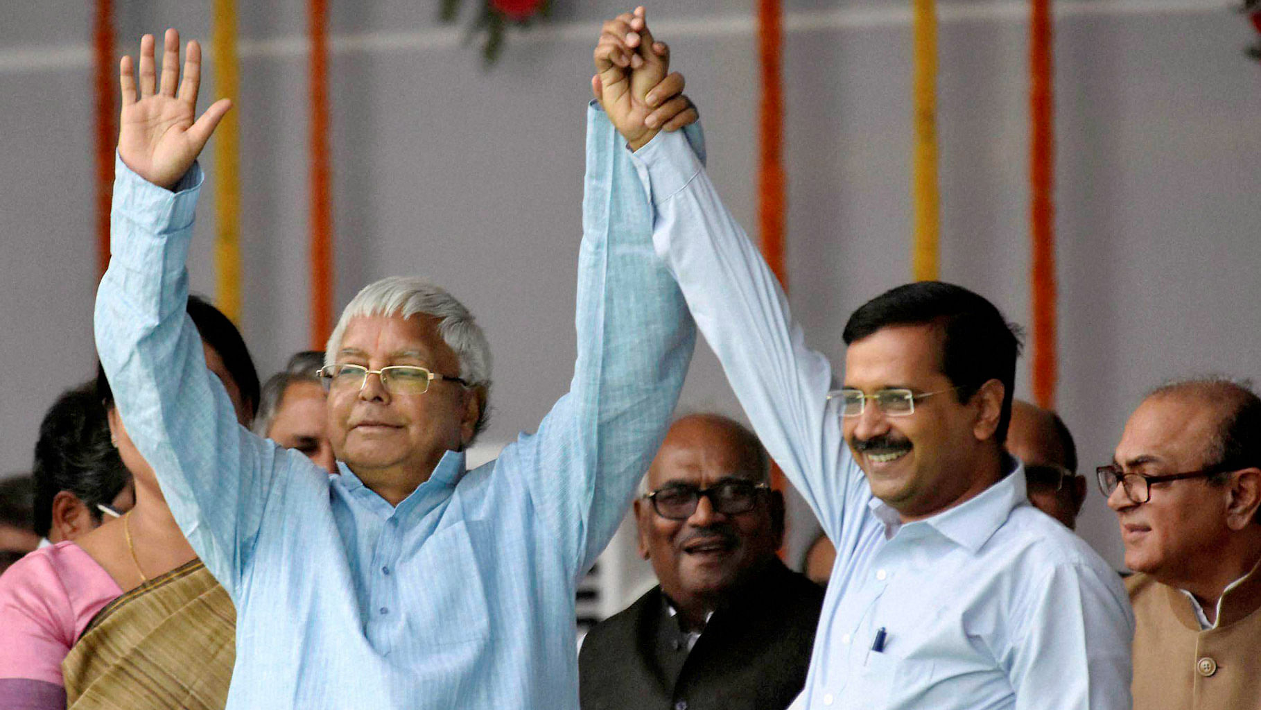 RJD chief Lalu Prasad with Delhi Chief Minister Arvind Kejriwal during the swearing-in ceremony of the new Bihar government at Gandhi Maidan in Patna, November 30, 2015. (Photo: PTI)