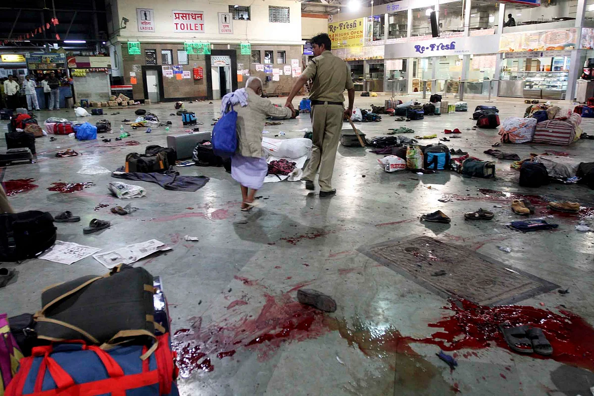 A policeman helping a senior citizen at CST soon after it was attacked. (Photo: Reuters)