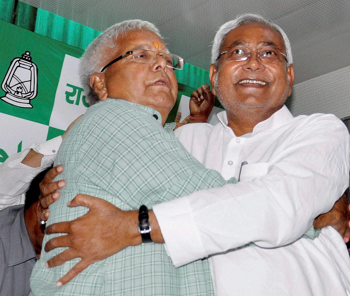 Bihar Chief Minister Nitish Kumar and RJD chief Lalu Prasad hug each other after Mahagathbandhan?s (Grand Alliance) victory in Bihar assembly elections at RJD office in Patna. (Photo: PTI) 