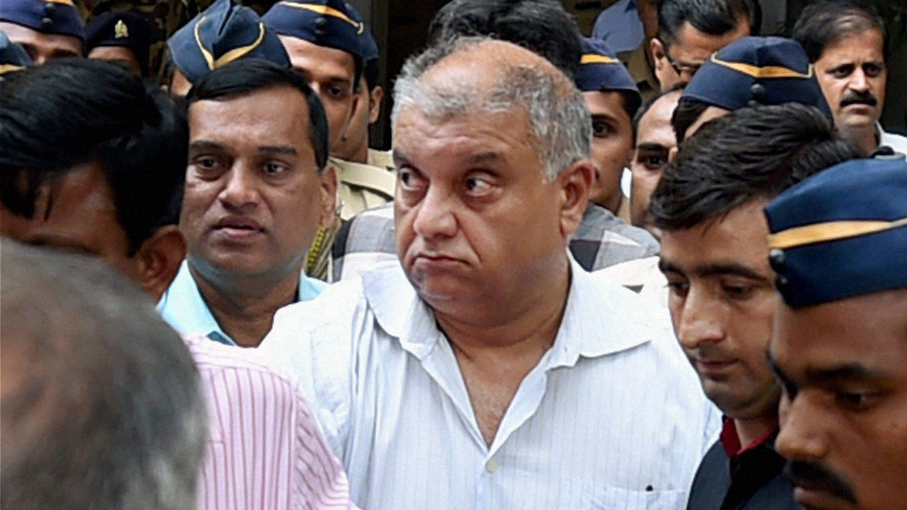 Peter Mukerjea is escorted after being produced by the CBI at the Esplanade court in Mumbai. (Photo: PTI)