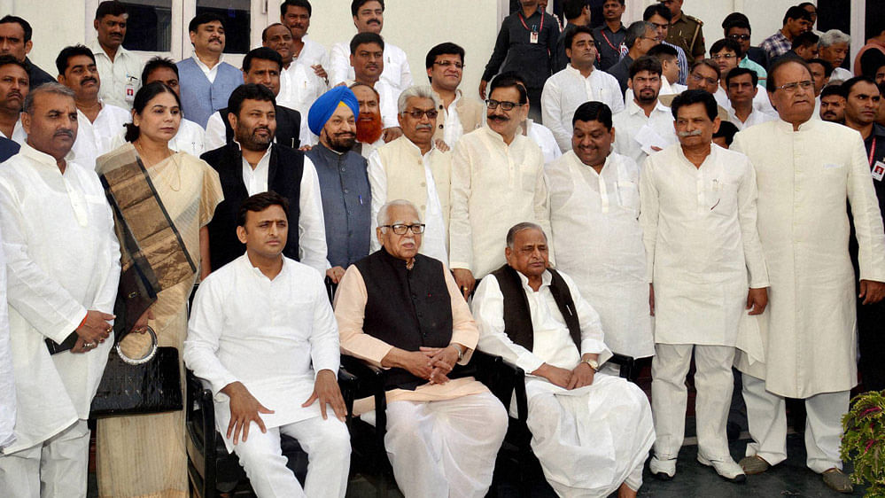 File picture of Samajwadi Party  chief Mulayam Singh Yadav and Uttar Pradesh Chief Minister Akhilesh Yadav in a group photo with newly inducted ministers after taking oath on 31 October 2015. (Photo: PTI)