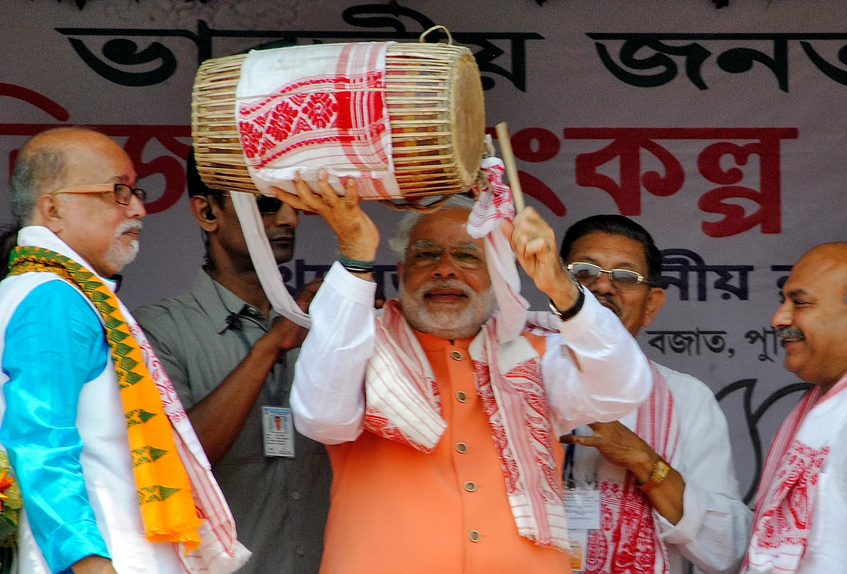 Narendra Modi plays a dhol, during an election campaign rally in Mangaldoi in Assam April 19, 2014. (Photo: Reuters)