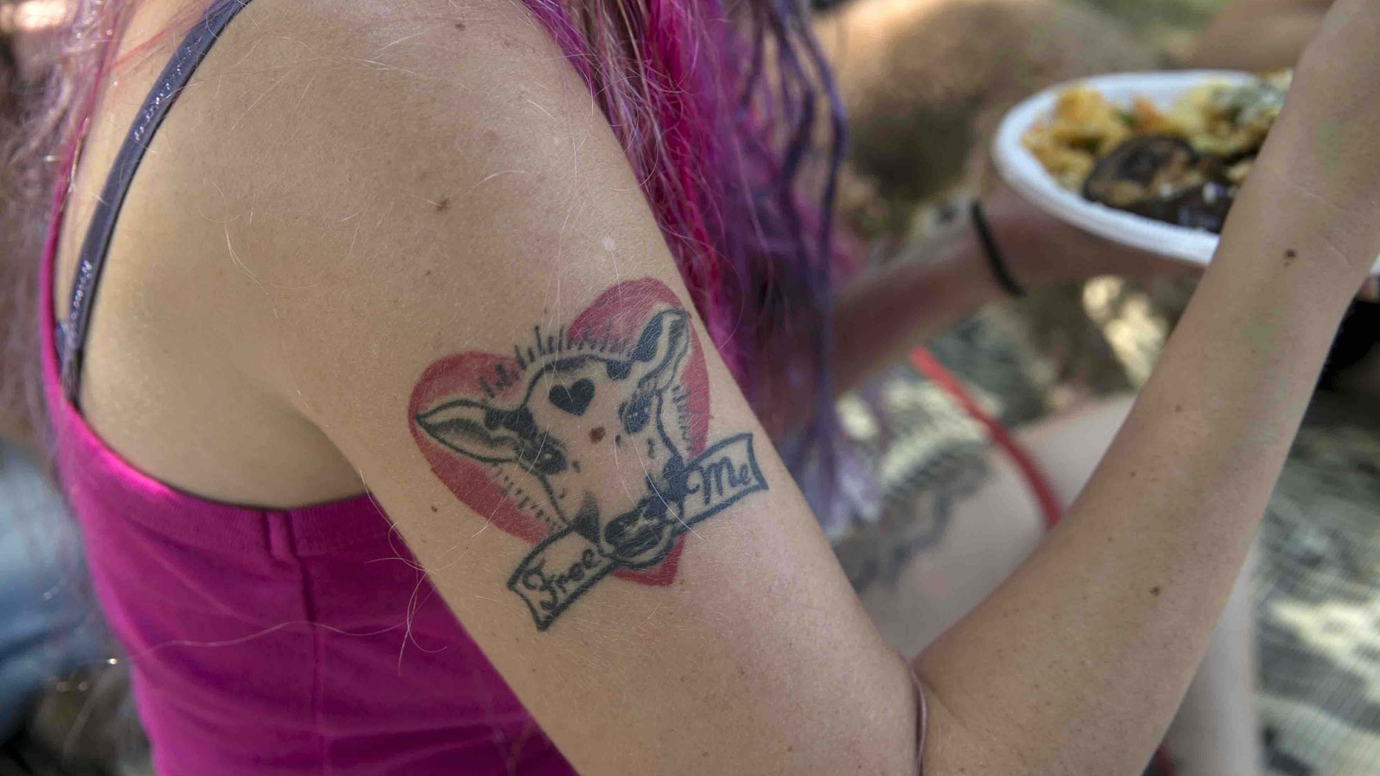 A tattoo is seen on the arm of a woman attending a vegan picnic at Hayarkon Park in Tel Aviv, Israel July 18, 2015. A growing trend has transformed Israel’s financial center into a haven for meatless cuisine. Some 400 food establishments are certified “vegan friendly,” including Domino’s Pizza, the first in the global chain to sell vegan pizza topped with non-dairy cheese. (Photo: Reuters)