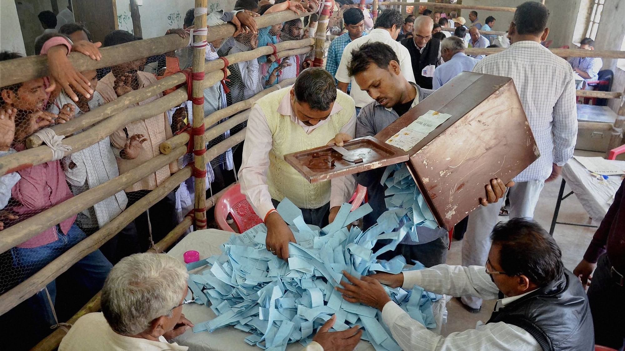 Election officials count votes of Uttar Pradesh Panchayat elections at a centre in Mirzapur on Sunday. (Photo: PTI)
