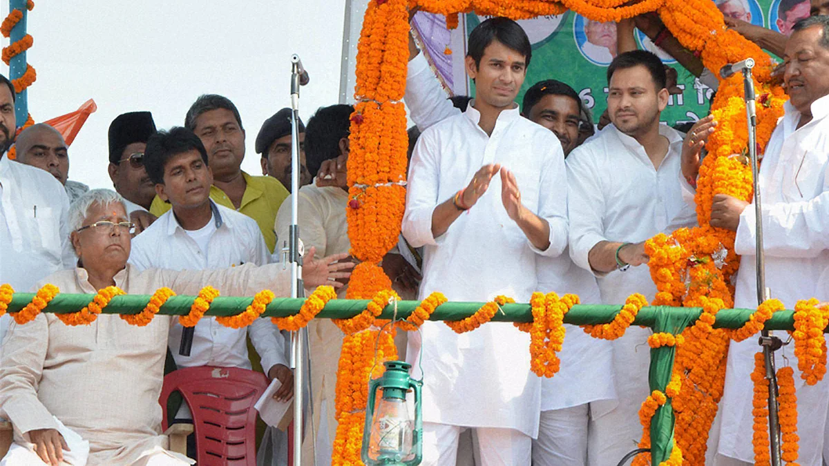 RJD Chief Lalu Yadav with his sons at a rally. (Photo: PTI)