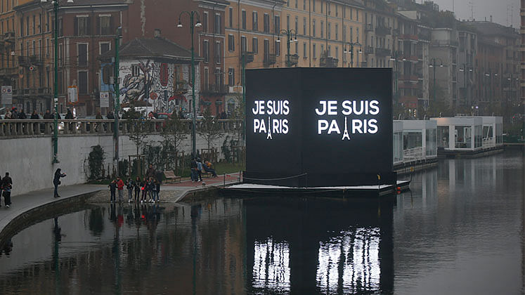 An electronic billboard on a canal in Milan, Italy, reads in French “I’m Paris” (Photo: AP)
