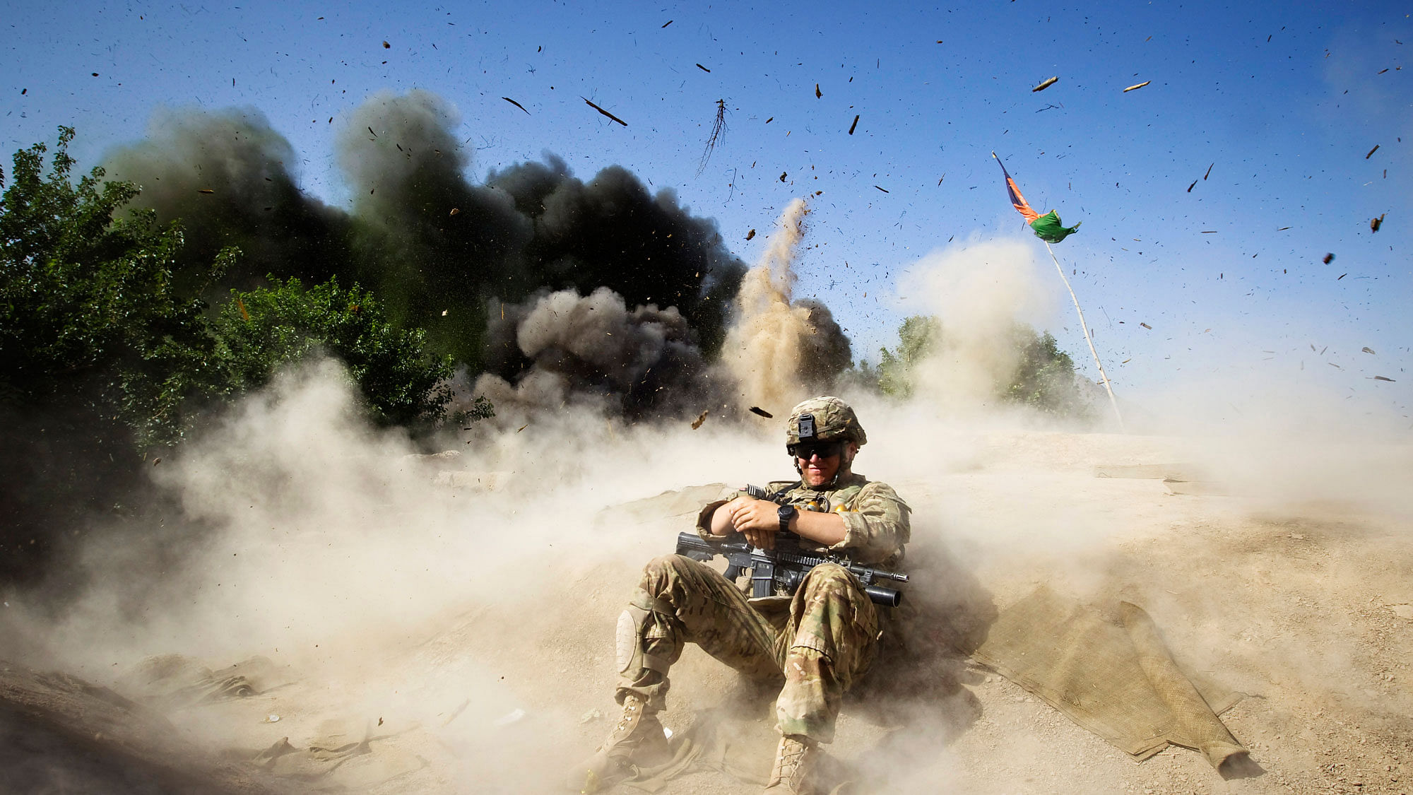 A US soldier takes cover during a controlled detonation to clear an area in  Kandahar province,  Afghanistan. (Photo: Reuters)