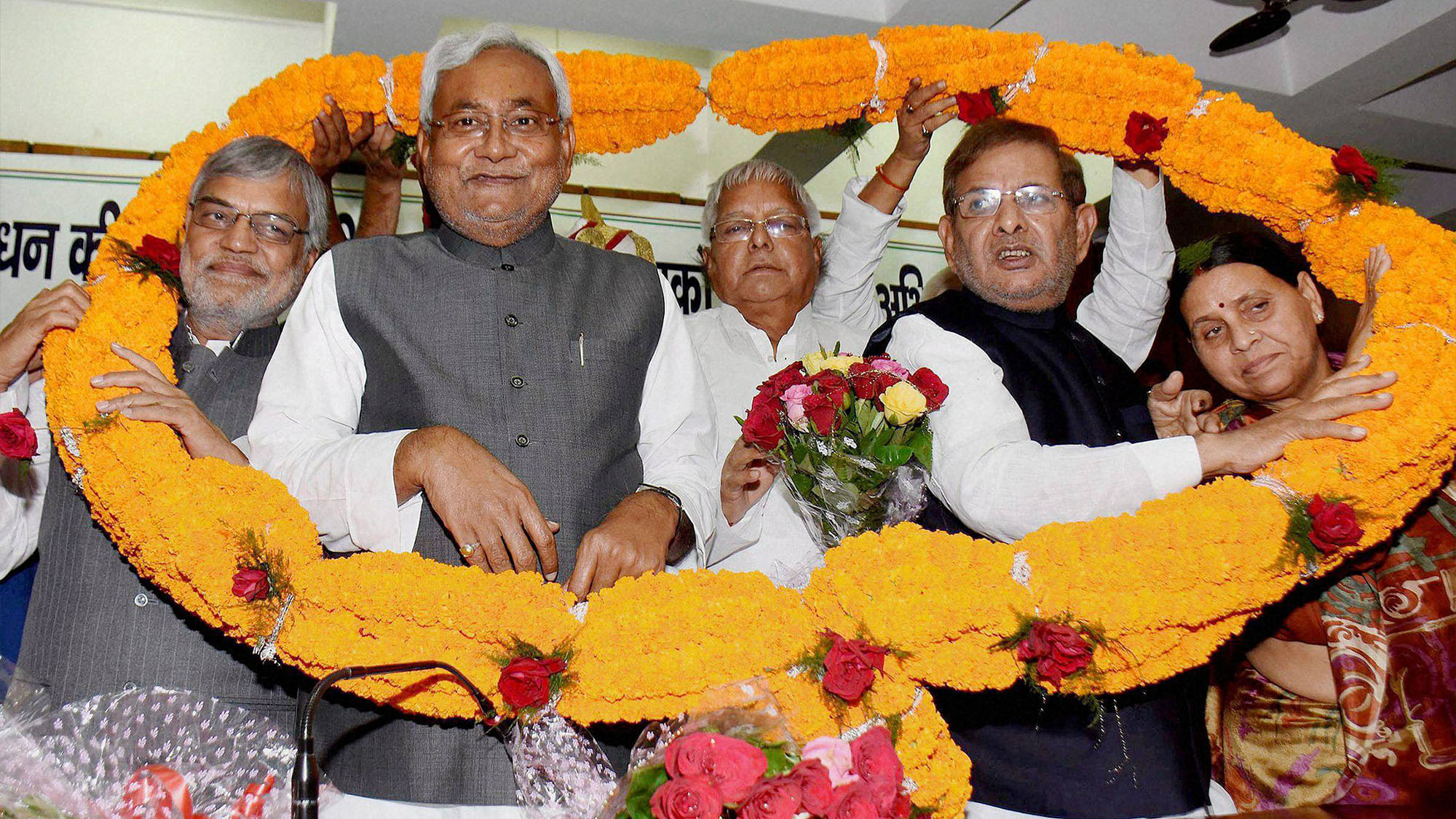 File photo of Bihar Chief Minister Nitish Kumar with RJD chief Lalu Prasad, JD(U) national president Sharad Yadav and Congress leader CP Joshi wearing garland after he was elected as grand alliance legislators leader in Patna.&nbsp;