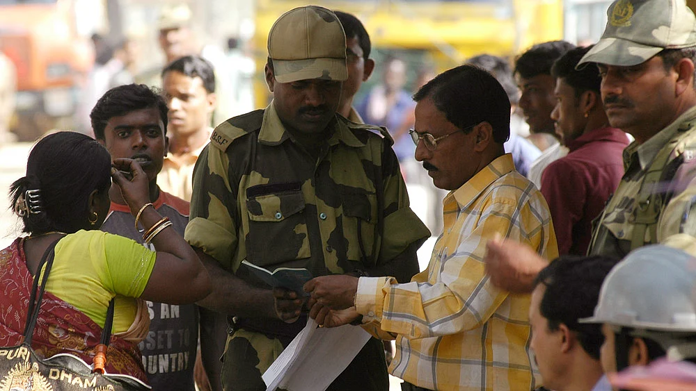 Indian Border Security Force (BSF) personnel and an immigration officer check the passport of a Bangladeshi citizen at Akhaura check-post of the India-Bangladesh border on the outskirts of Agartala. (File Photo: Reuters)