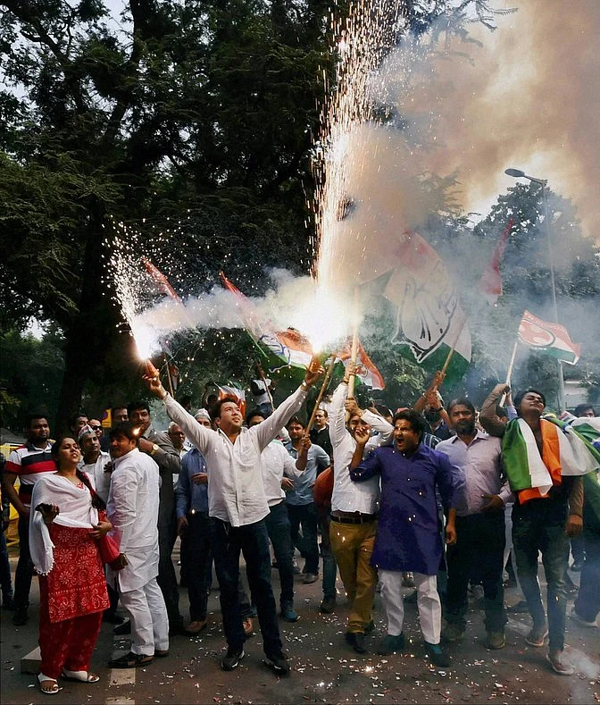 Congress supporters burn crackers as they celebrate Bihar poll results, at party headquarters in New Delhi on Sunday. (Photo: PTI)