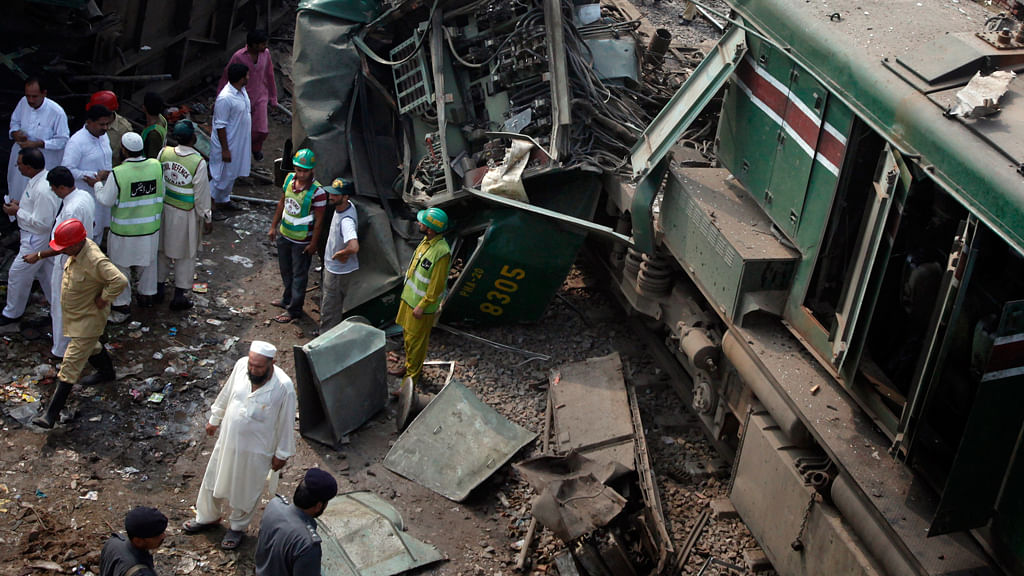 Railway officials and rescue workers gather near the wreckage of a train accident on the outskirts of Lahore on August 30, 2011. (Photo: Reuters) &nbsp;