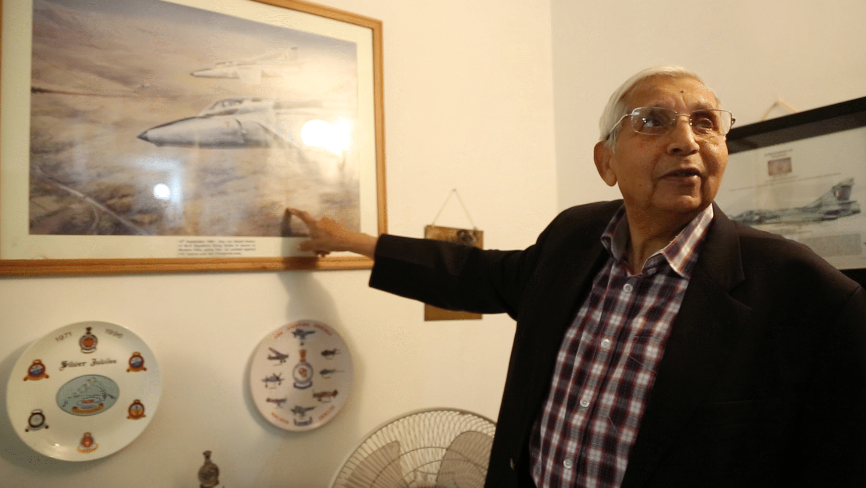 Keelor pointing towards an artist’s rendition of his famous dogfight with the Pakistani Air Force Sabre jets. (Photo: <b>The Quint</b>)