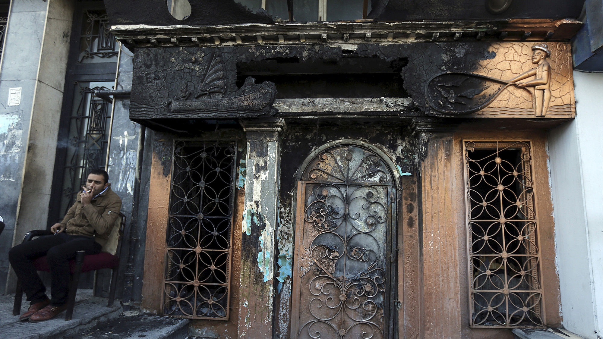 A policeman sits  in front of the restaurant that was attacked in Cairo, Egypt on Friday. (Photo: Reuters)