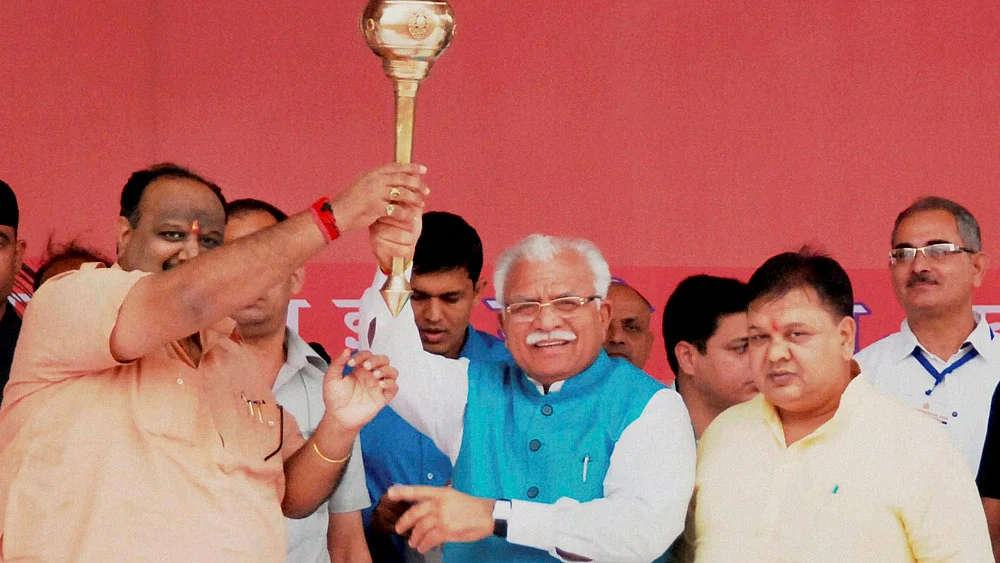 Haryana Chief Minister Manohar Lal Khattar raising a mace at an event to commemorate the first anniversary of the state government in Sirsa on October 25, 2015. (Photo: PTI) 