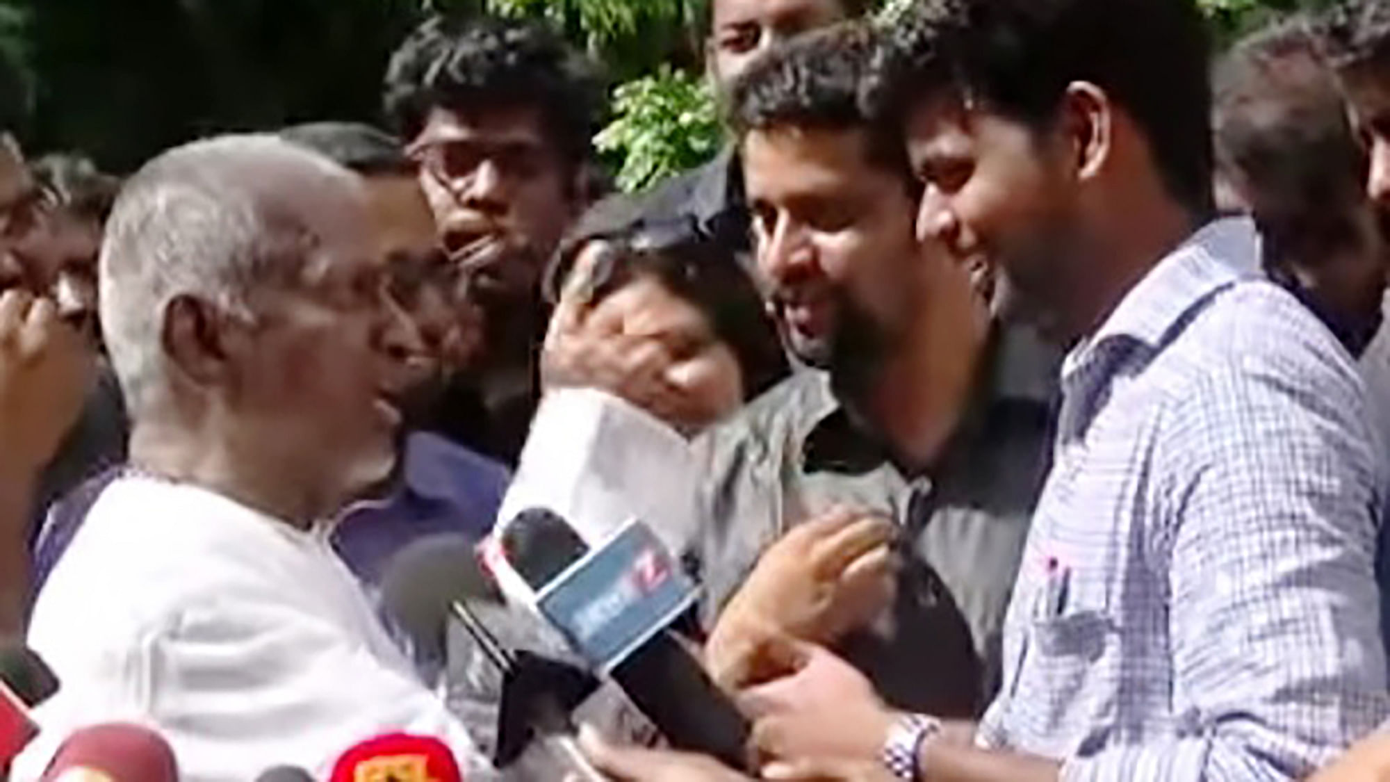 Ilayaraja gives it back to the journalist. (Photo: <i>The News Minute</i>)