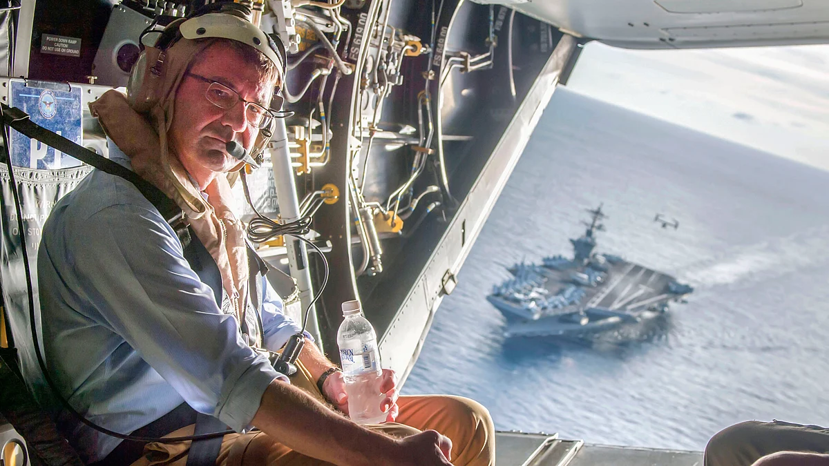 The <i>USS Theodore Roosevelt</i> can be seen in the background as US Secretary of Defence Ash Carter flies in a V-22 Osprey after visiting the aircraft carrier in the South China Sea, in this handout photograph released on November 5, 2015. (Photo: Reuters)