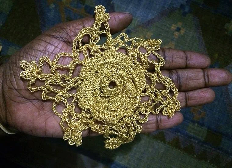 Artist Mithu Sen holding the gold crochet gifted to her by Hema (Photo courtesy: Mithu Sen)