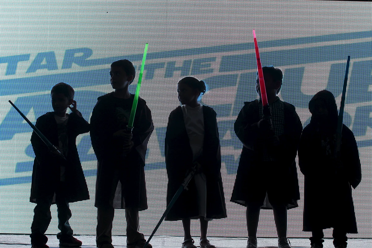 Children dressed as Jedi characters from <i>Star Wars</i> participate in a game during an event held for the release of <i>Star Wars: The Force Awakens</i>. (Photo: Reuters)
