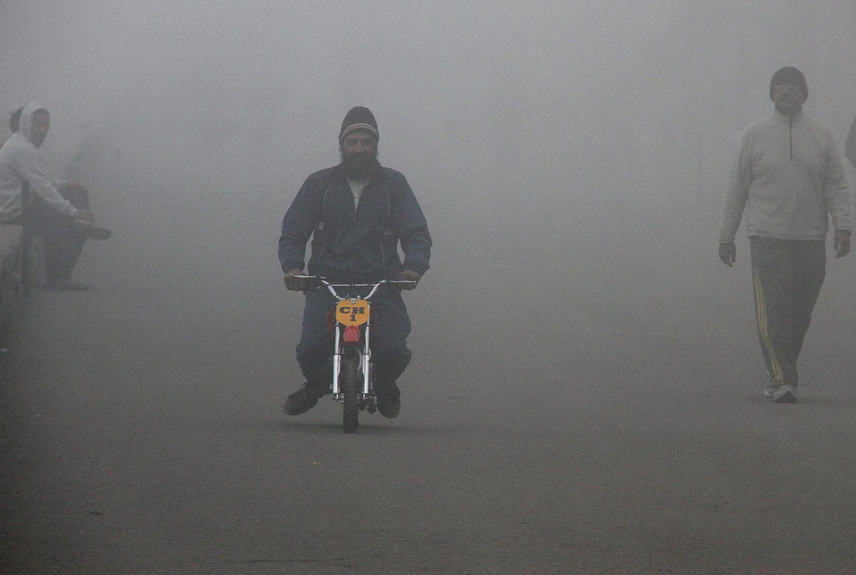 Man riding a motorcycle on a foggy morning in Chandigarh. (Photo: Reuters)