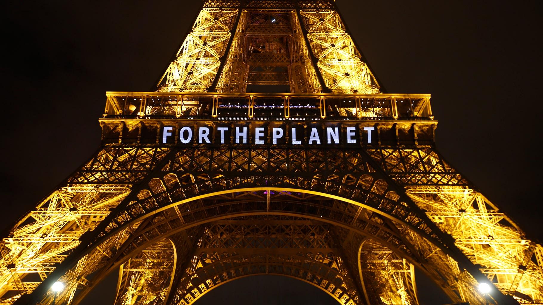 The slogan “FOR THE PLANET” projected on the Eiffel Tower as part of the COP21, United Nations Climate Change Conference in Paris, France. (Photo: AP)