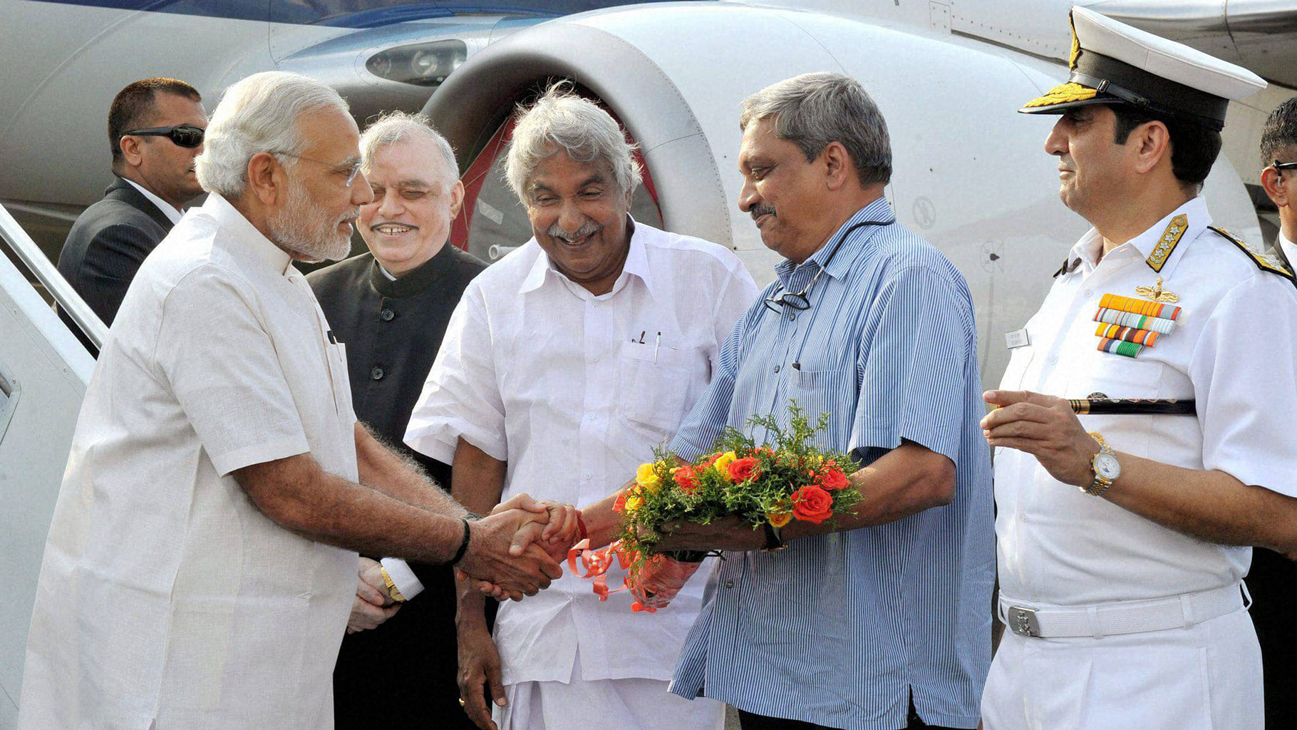 Prime Minister Narendra Modi being received by the Governor of Kerala, P. Sathasivam, CM Oommen Chandy and the Union Minister for Defence, Manohar Parrikar at Kochi. (Photo: PTI)