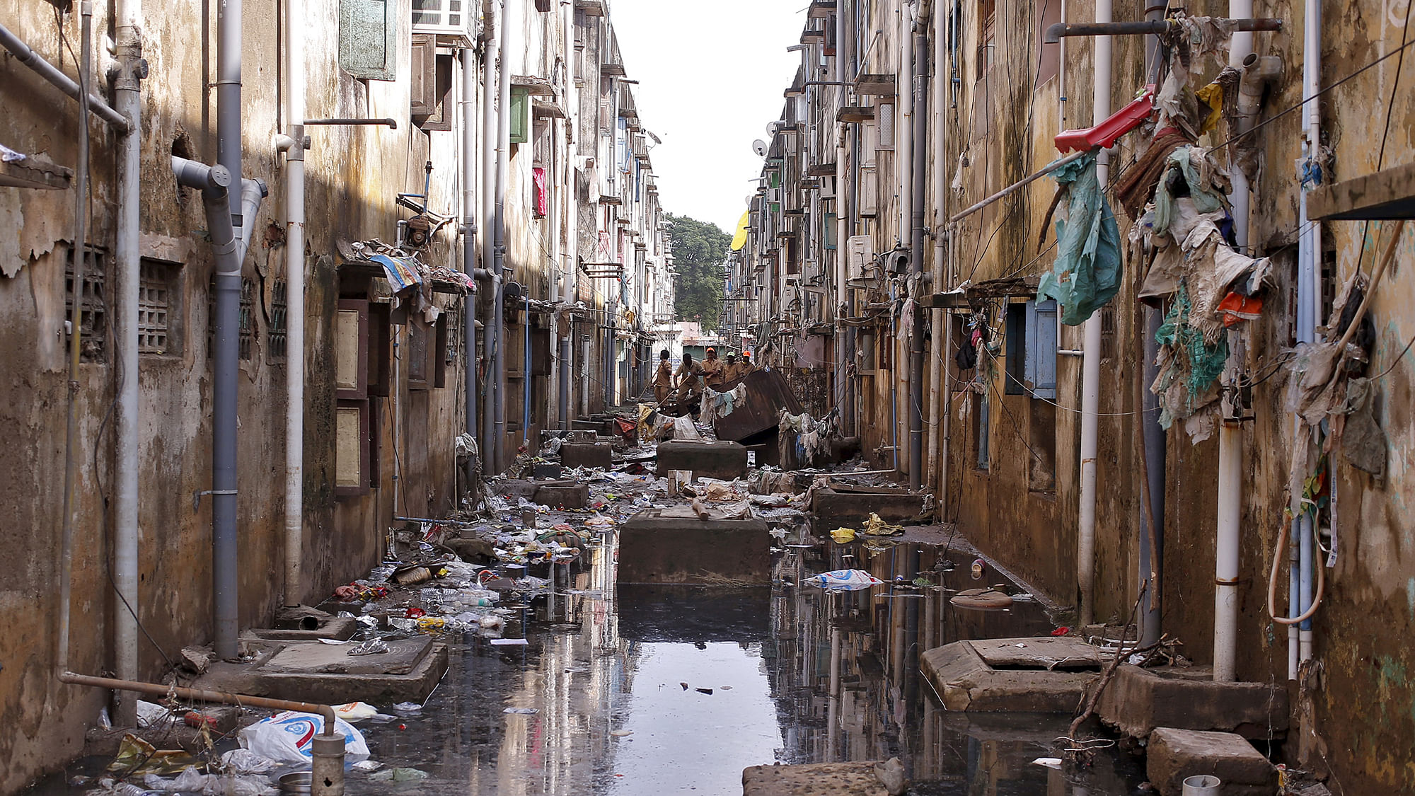 Municipal workers clearing the debris in an alley after flood waters receded in Chennai. (Photo: Reuters) 