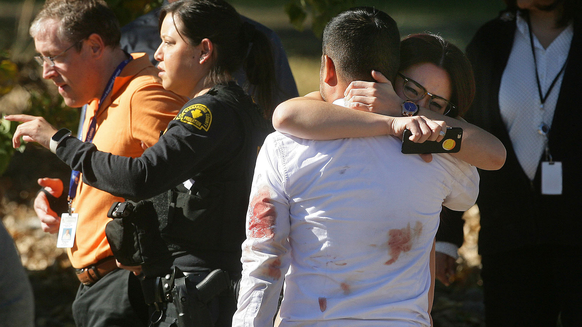 A couple embraces following the California shooting that
killed multiple people at a social services facility. (Photo: AP)