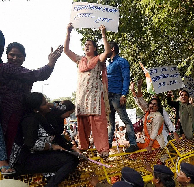 Congress women workers mount police barricades while protesting against the central government in the wake of the controversy generated by the <i>National Herald</i> case at Teen Murti in New Delhi on Tuesday. (Photo: PTI)