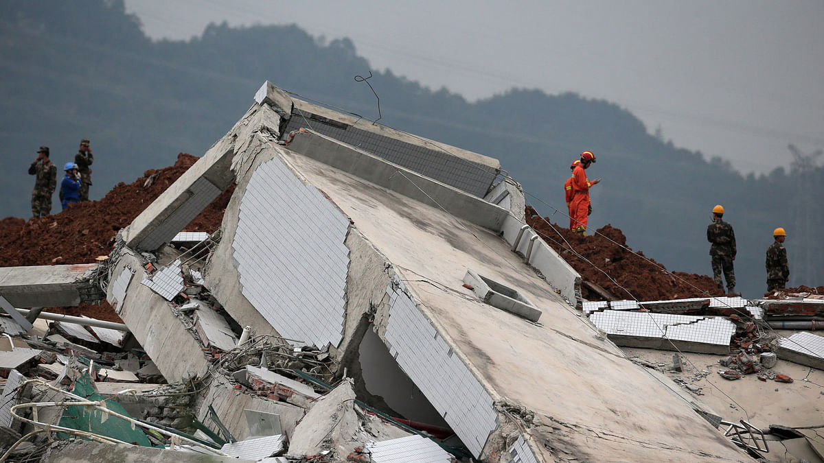 

Rescuers recover one body from rubble after more than 80 people went missing in a landslide in southern China.