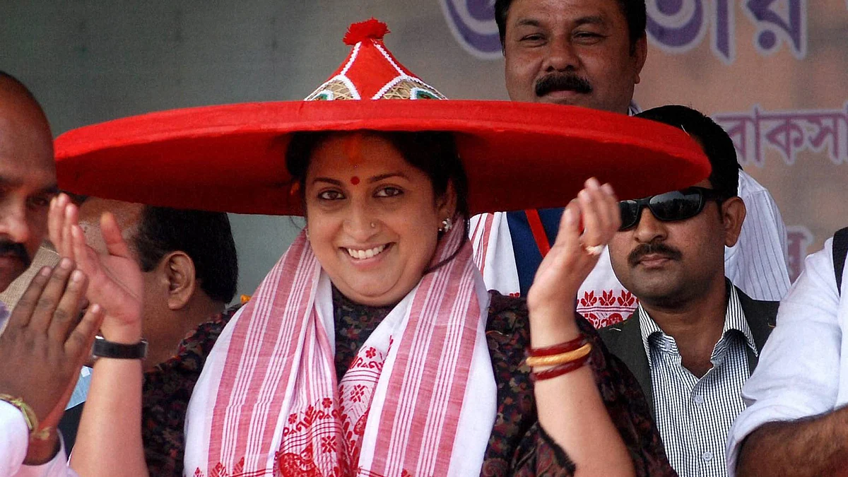 HRD Minister Smriti Irani being felicitated with an Assamese <i>japi</i> during a public meeting in Nalbari on Monday. (Photo: PTI)