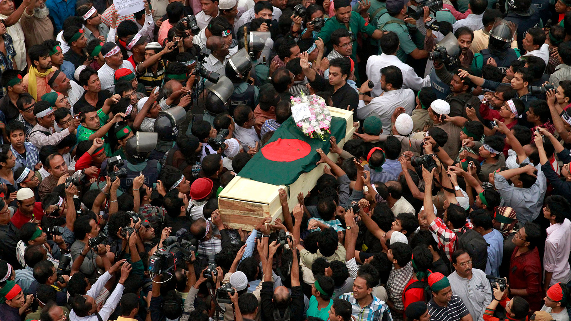 People surround the body of Rajib Haider, an
architect and blogger who was hacked to death in 2013. (Photo: Reuters)