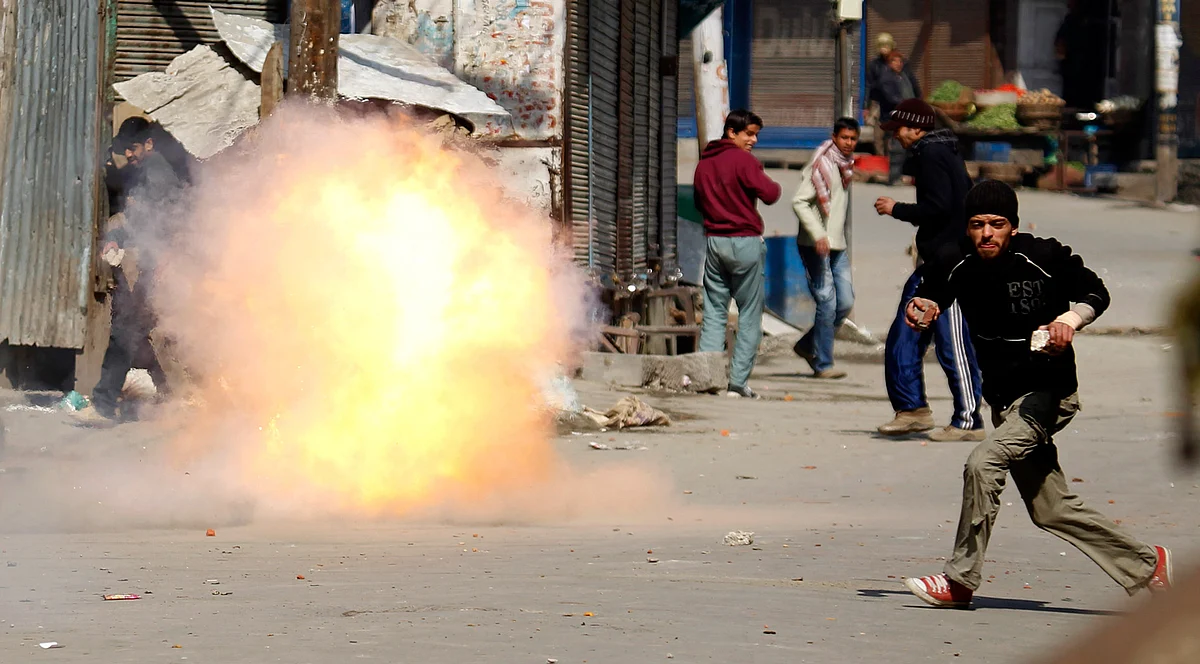 A protester runs from a tear gas shot by police explodes on February 20, 2013.