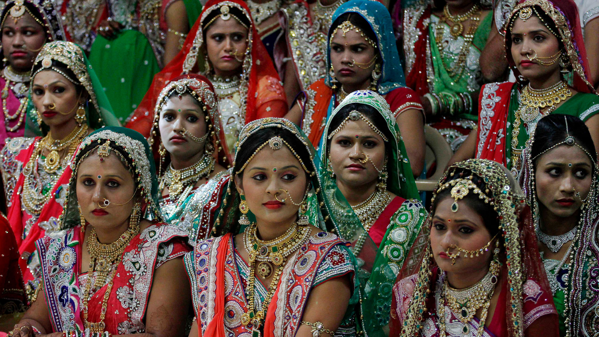 Brides sit for a group photo before a mass wedding hosted by a diamond trader, Mahesh Savani in Surat.&nbsp;