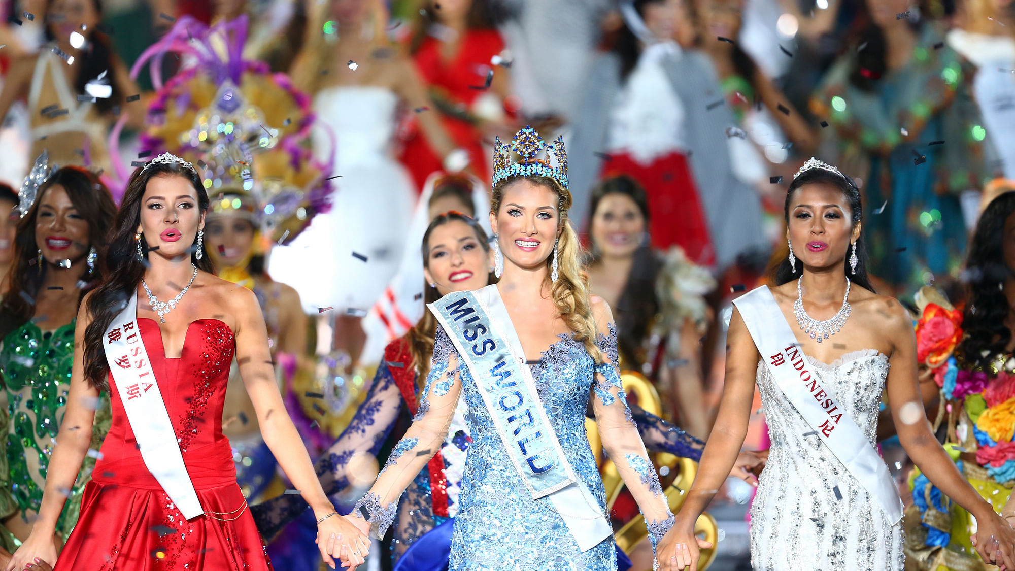 Miss World Mireia Lalaguna Royo from Spain, center, Sofia Nikitchuk from Russia, left, the runner-up, and Maria Harfanti from Indonesia, right, the second runner-up celebrate at the end of the 2015 Miss World Grand Final in Sanya in south China’s Hainan province Saturday Dec. 19, 2015. (Photo: AP)