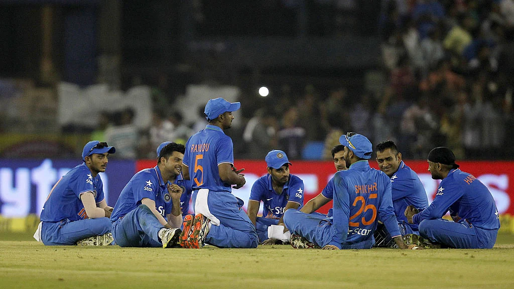 The Indian cricket team sits in a circle and waits for the crowd’s heroics to subside. (Photo: Reuters)