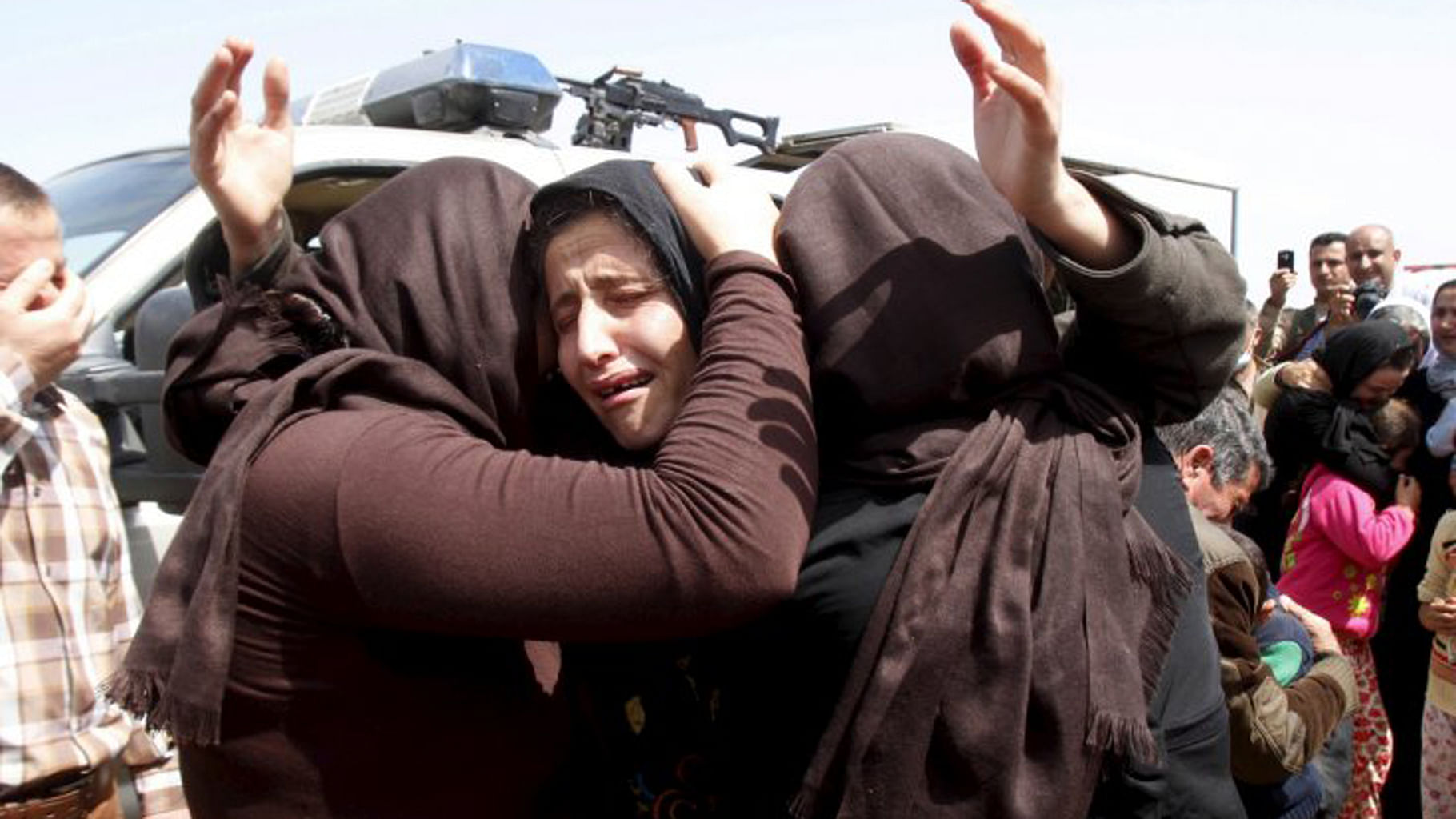 Members of the minority Yazidi sect who were released by ISIS, hug each other on the outskirts of Kirkuk. Photo used for representational purpose. (Photo: Reuters),