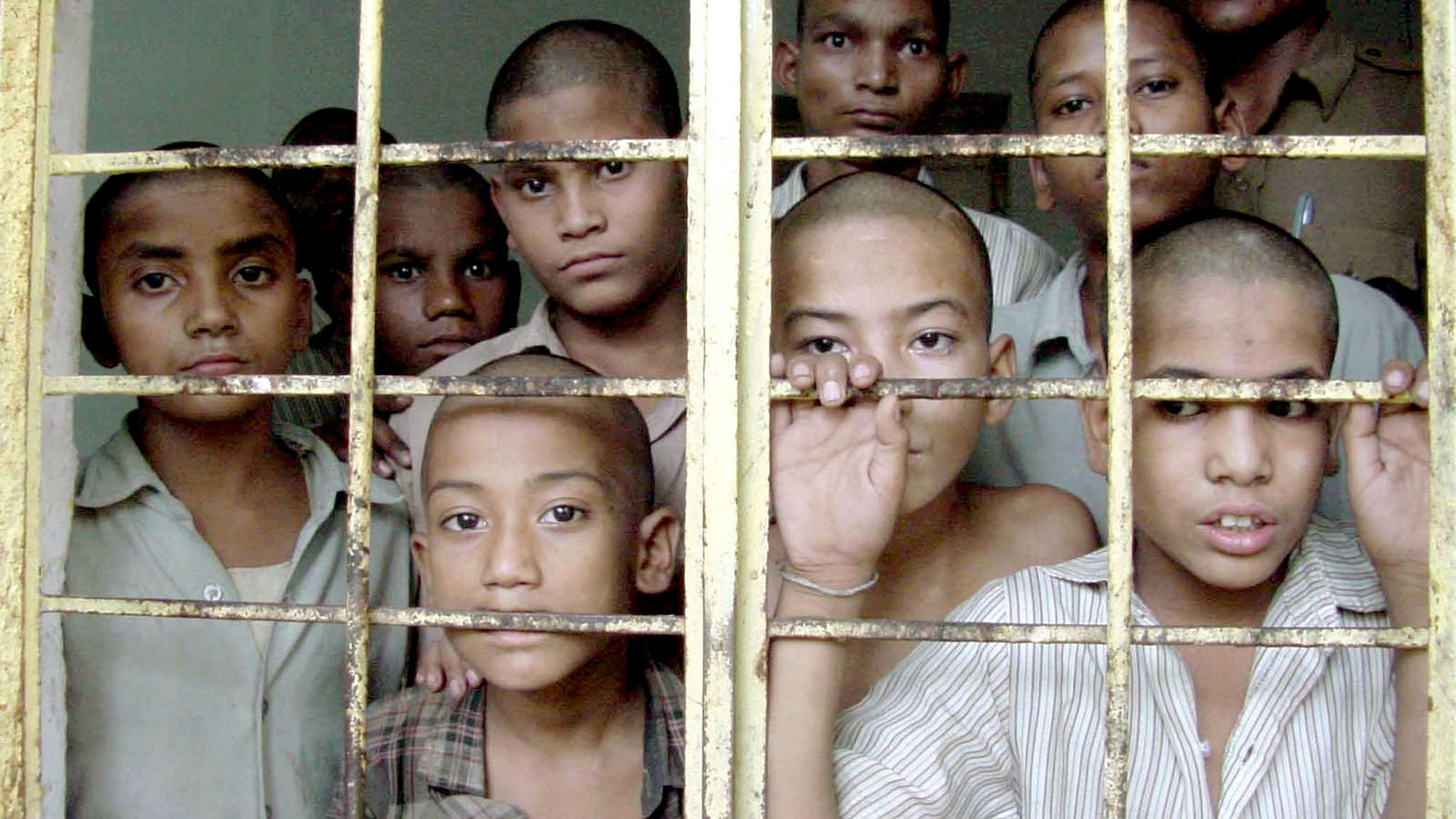 Juveniles look out of a cell of a reform home in Bhopal. (Photo: Reuters)