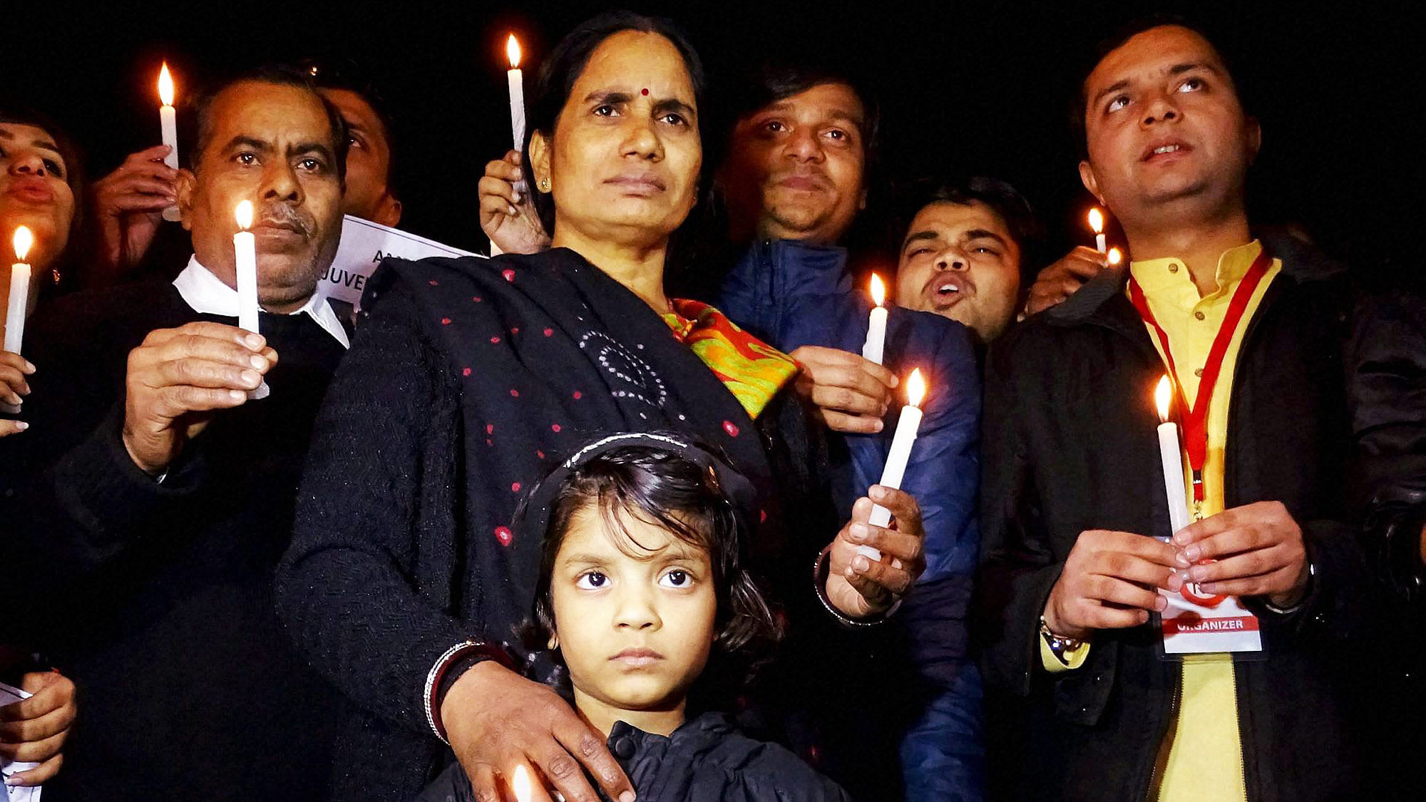 Asha Devi, the mother of December 16 gangrape victim Jyoti Singh also known as Nirbhaya, holds a candle at the vigil held for her daughter.  (Photo: PTI)