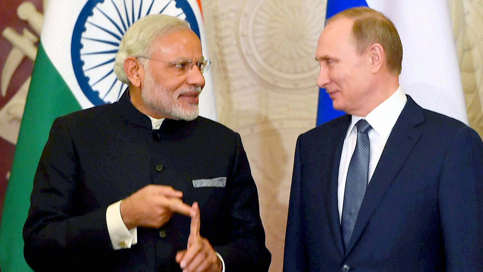 Prime Minister Narendra Modi talks with Russian President Vladimir Putin during signing of MOU at Kremlin Moscow on Thursday. (Photo: PTI)