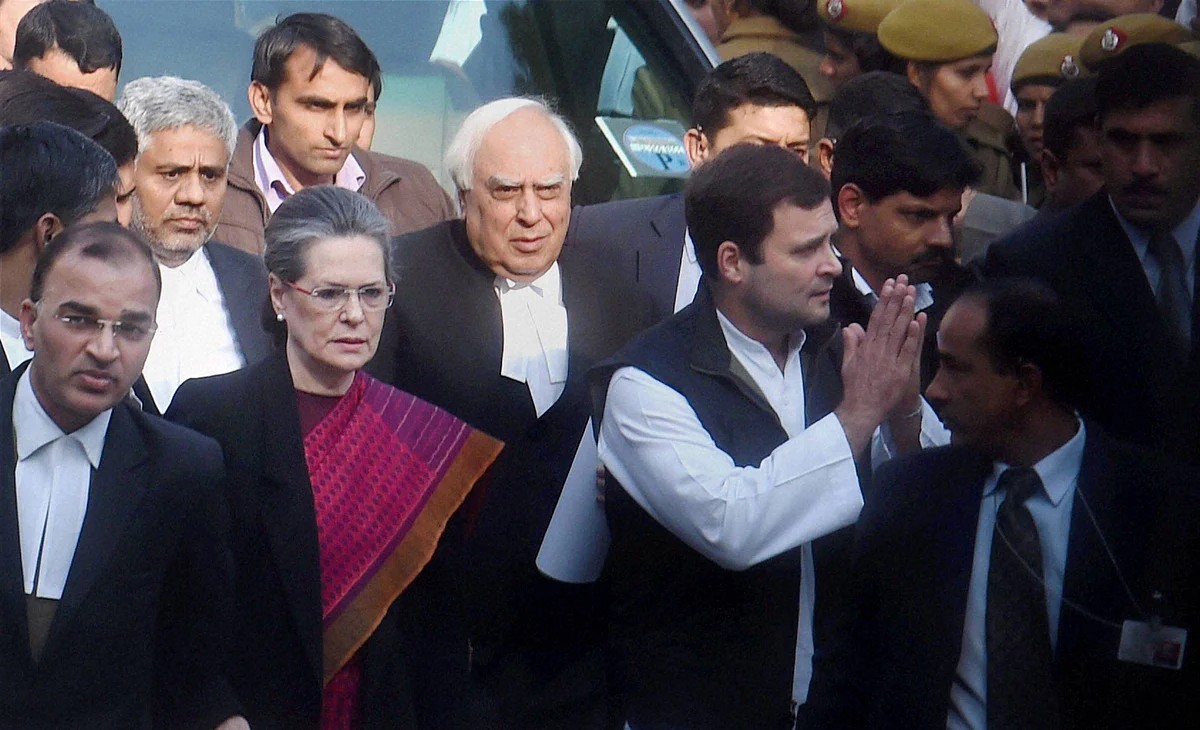 Congress President Sonia Gandhi and party Vice President Rahul Gandhi come out after attending a hearing in<i> The National Herald</i> Case at the Patiala House Courts. (Photo: PTI)