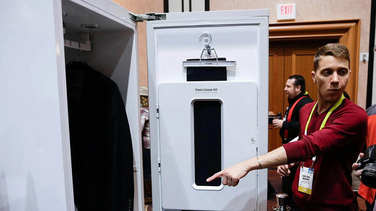 Colton Moore points at the LG Styler from LG at CES Unveiled, a media preview event for CES International, Monday, 4 January 2016, in Las Vegas. The device uses steam and other items to maintain clothing. (Photo: AP/Gregory Bull)