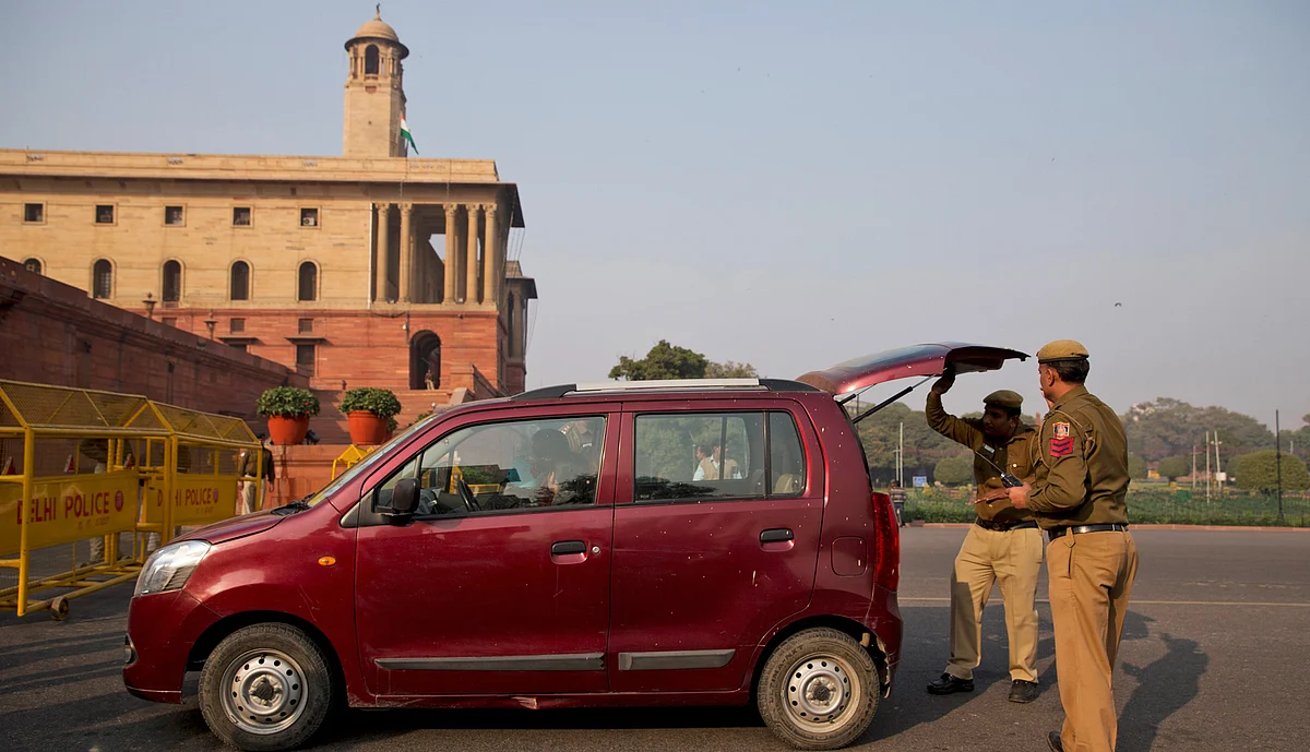 Policemen check a car near the Rashtrapati Bhavan as part of enhanced security measures following the attack. (Photo: AP)