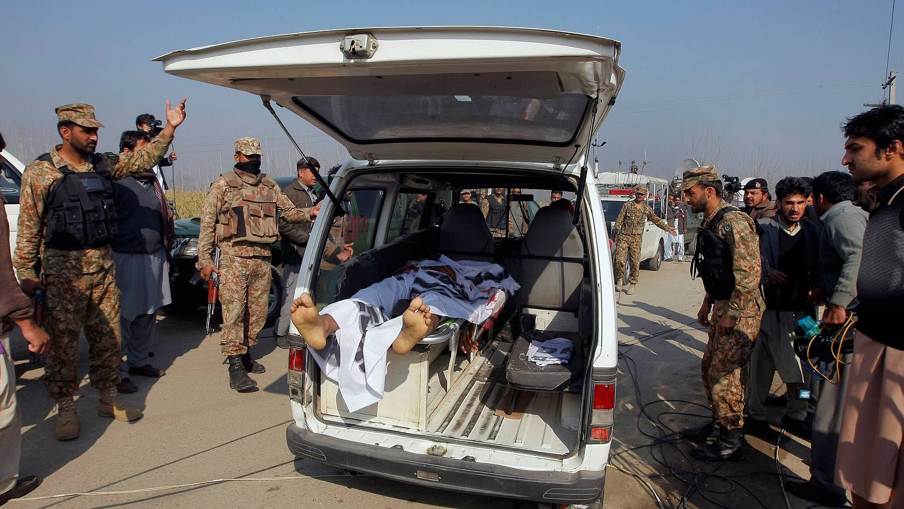  Pakistani troops clear way for an ambulance transporting the body of a victim from Bacha Khan University in Charsadda town. (Photo: AP)
