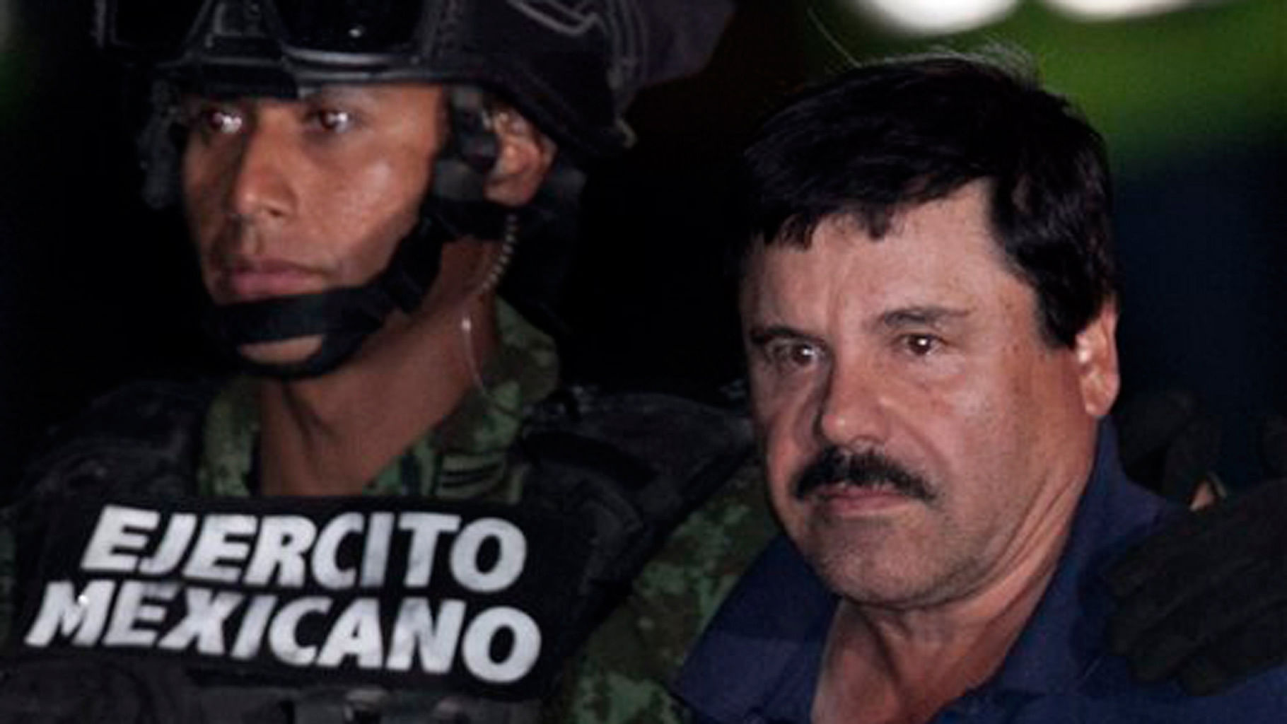 Mexican drug lord Joaquin “El Chapo” Guzman, right, is escorted by soldiers and marines to a waiting helicopter. (Photo: AP)